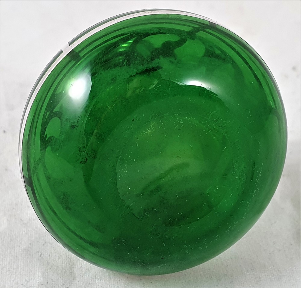 An emerald green glass perfume bottle featuring silver overlay in geometric and linear patterns with a matching silver-covered globe stopper. View VIII