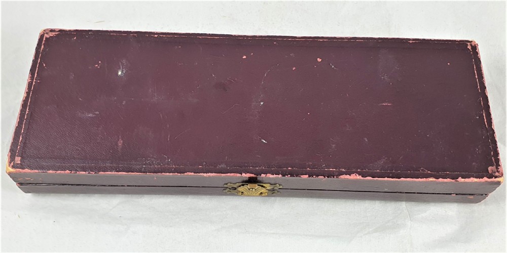 A nineteenth-century French silver-plated sugar sifter featuring a pierced shell-shaped gilded bowl and relief handle, presented in a dark fitted case. View XVIII