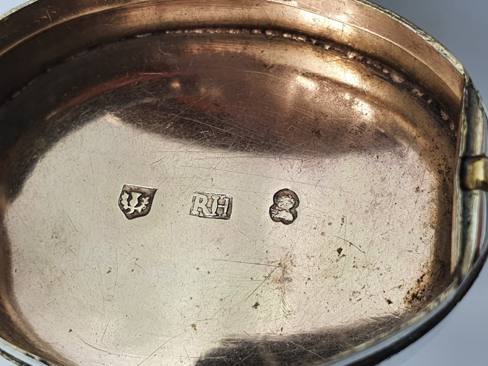 A Georgian oval silver vinaigrette featuring a smooth brown agate top and engraved script monogram on the silver collar. View XIII