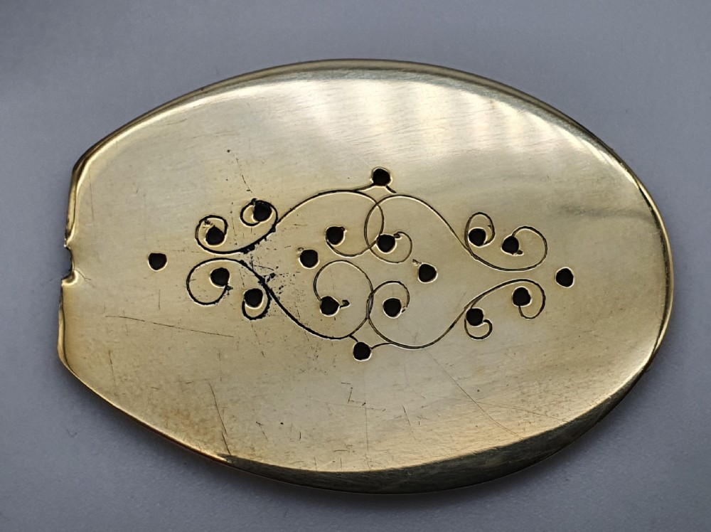 A Georgian oval silver vinaigrette featuring a smooth brown agate top and engraved script monogram on the silver collar. View XV
