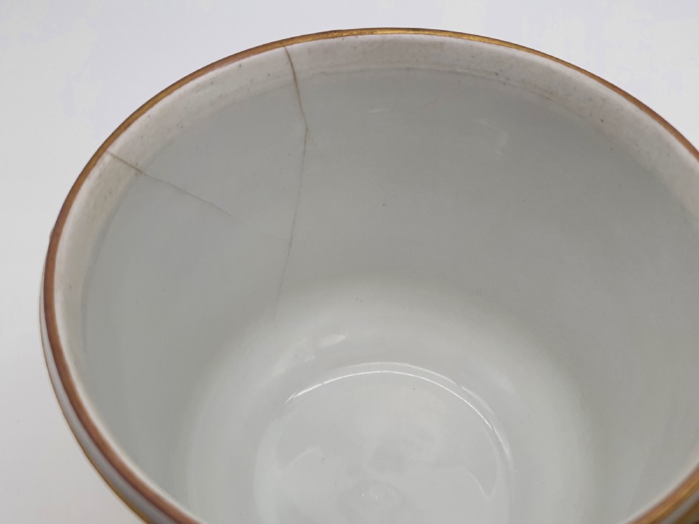 A yellow and white Dresden porcelain cache pot featuring side handles, gold gilding, and a central cartouche depicting a purple painted pastoral scene. View IX