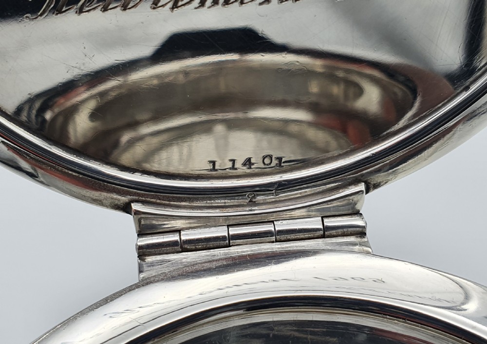 A late Victorian claret jug featuring a diamond-cut clear glass body paired with a polished sterling silver collar, hinged flat lid, fluted finial, and clear glass handle. View XVI