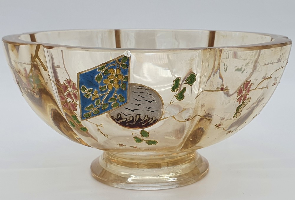 A footed amber crystal bowl featuring hand-enamelled Japanese-inspired floral motifs and geometric panels.