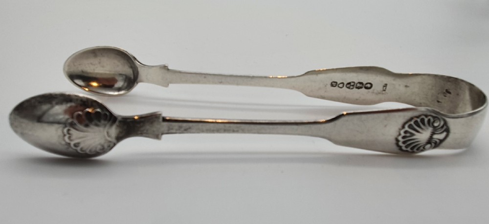 A pair of Victorian silver sugar tongs featuring shell motifs and spoon-shaped grips. View II