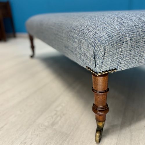 LARGE NEWLY UPHOLSTERED FOOTSTOOL ON REGENCY LEGS WITH CASTORS - ADDITIONAL PHOTO 1
