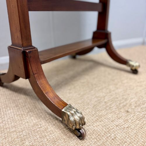 fig 1. A Regency mahogany cheval mirror featuring a rectangular swivelling mirror frame, turned finials, boxwood inlay, and splayed legs ending in brass castors.