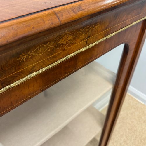 fig 1. Victorian walnut pier cabinet featuring a single glazed door, floral marquetry inlay on the frieze, brass rim trim, and a three-tier fabric-lined interior.