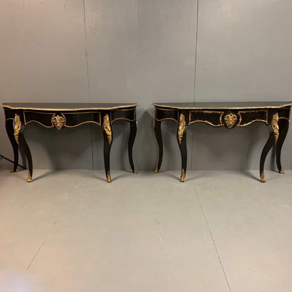 Pair of French ebonised console tables with brass mounts View II