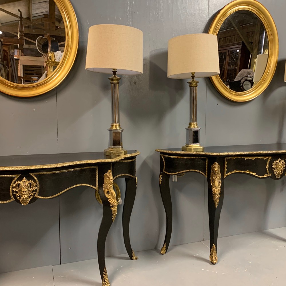 Pair of French ebonised console tables with brass mounts View X