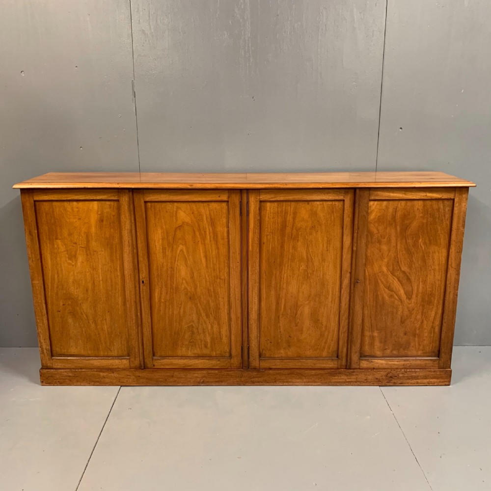 Slim four door mahogany low bookcase 