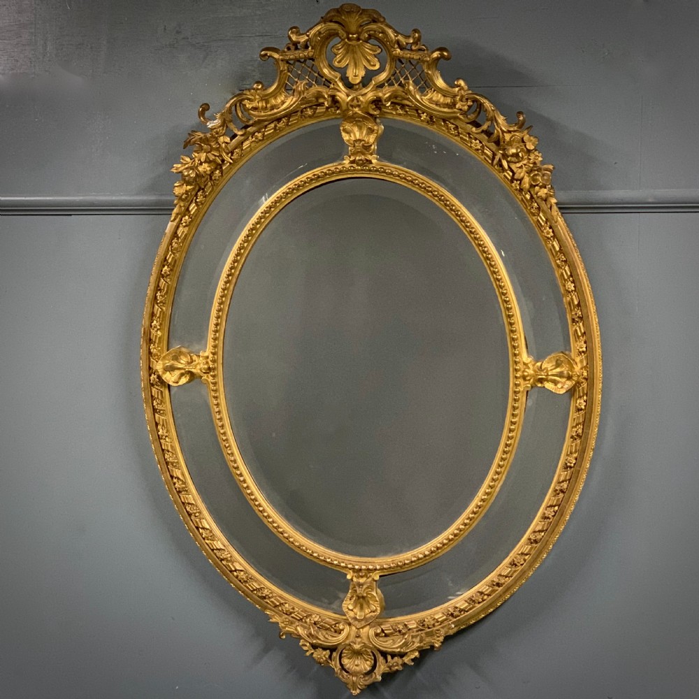 Large 56'' French oval Louis XVI style gilt bevelled mirror