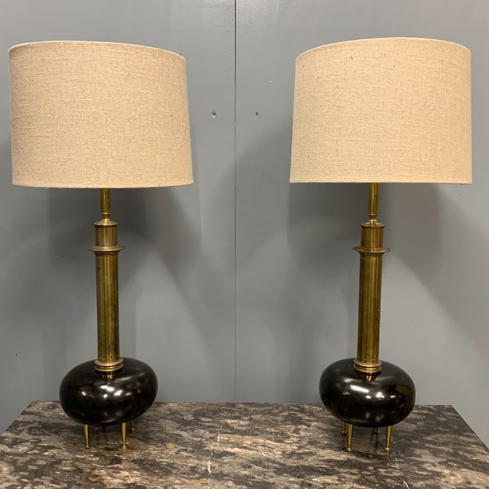 Pair of bulbous ebonised and brass lamps 