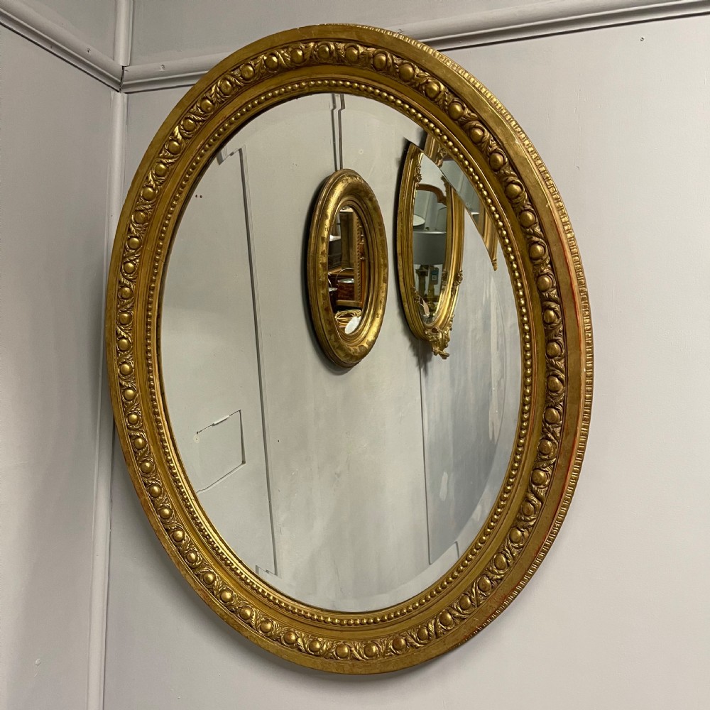 Large French oval gilt mirror with original glass