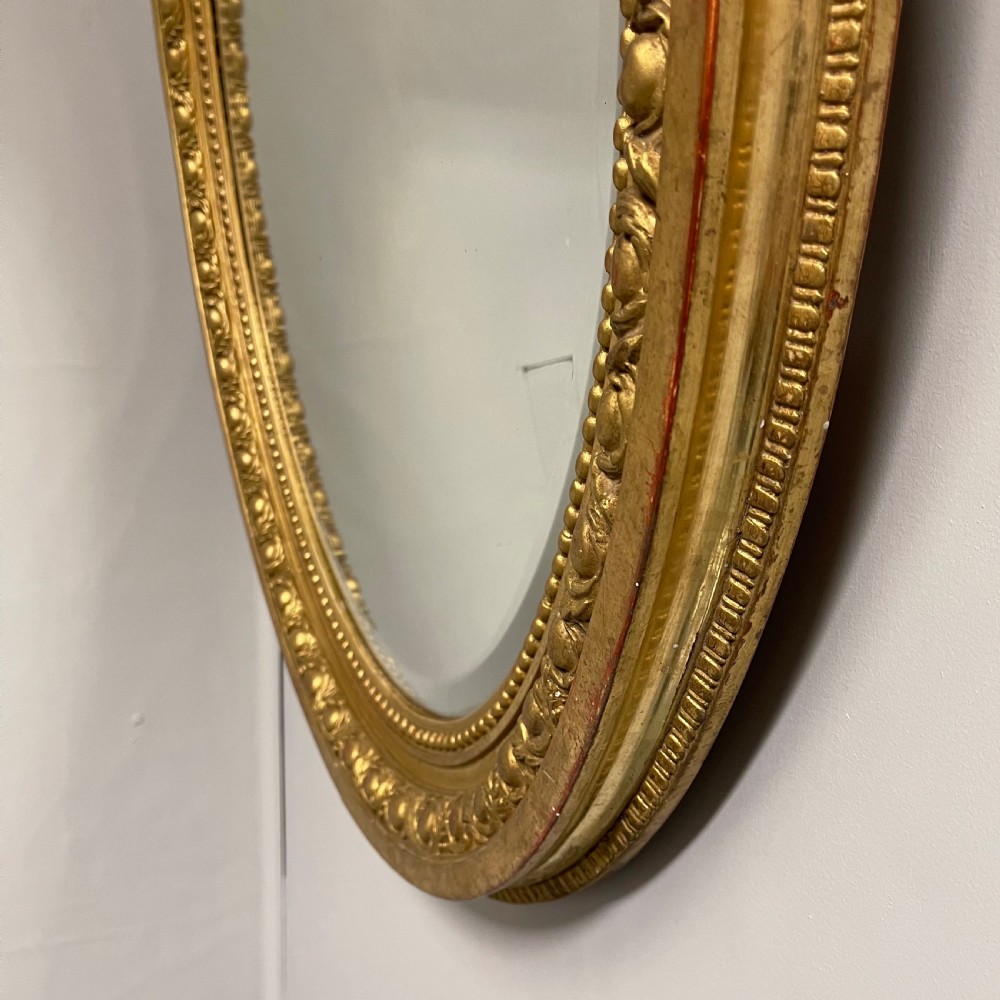 Large French oval gilt mirror with original glass View II