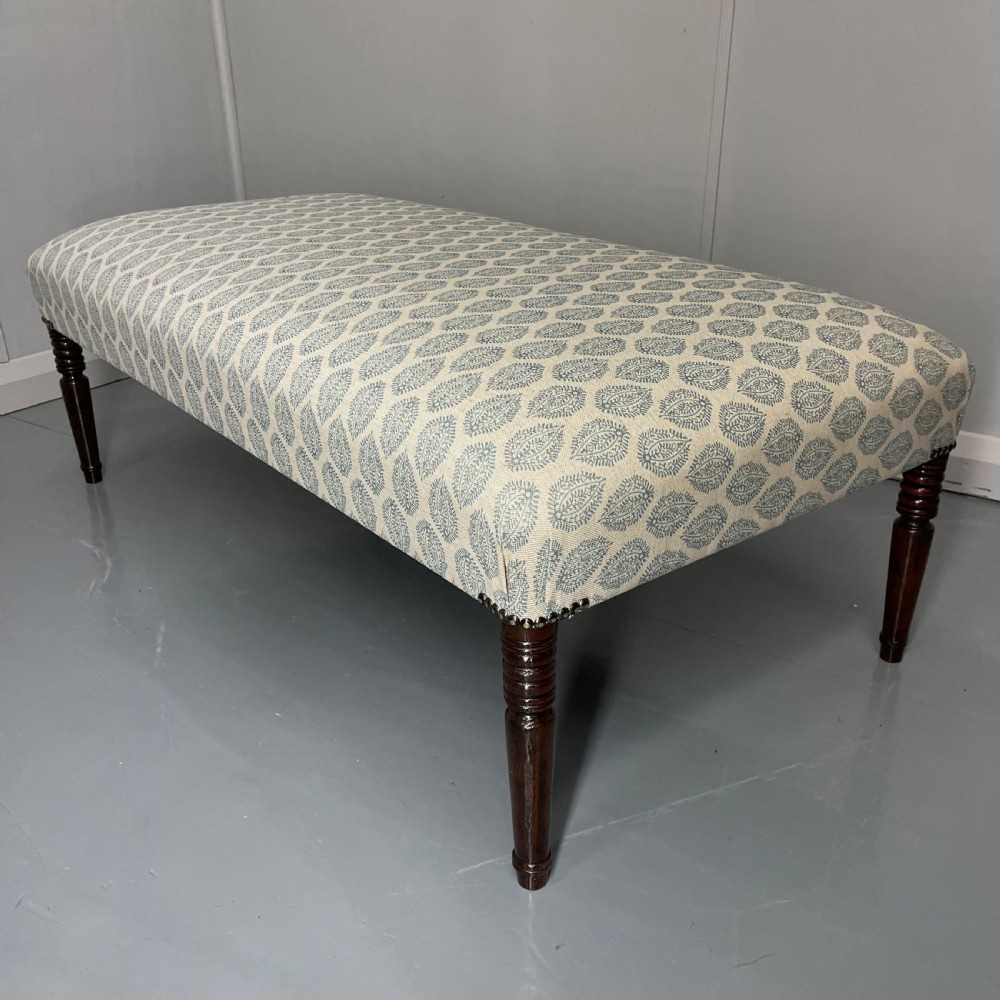 Regency footstool with turned legs and leaf motif