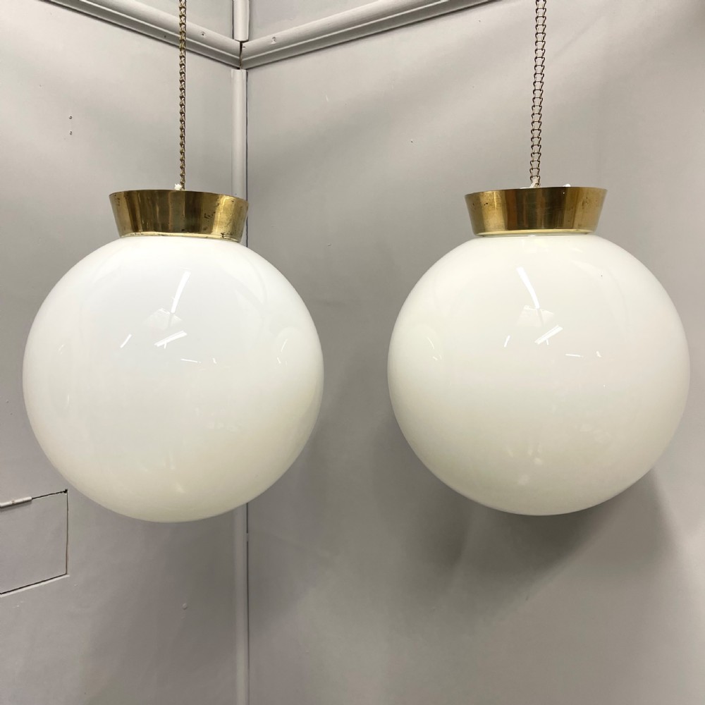 Pair of opaline milk glass globe pendant lights