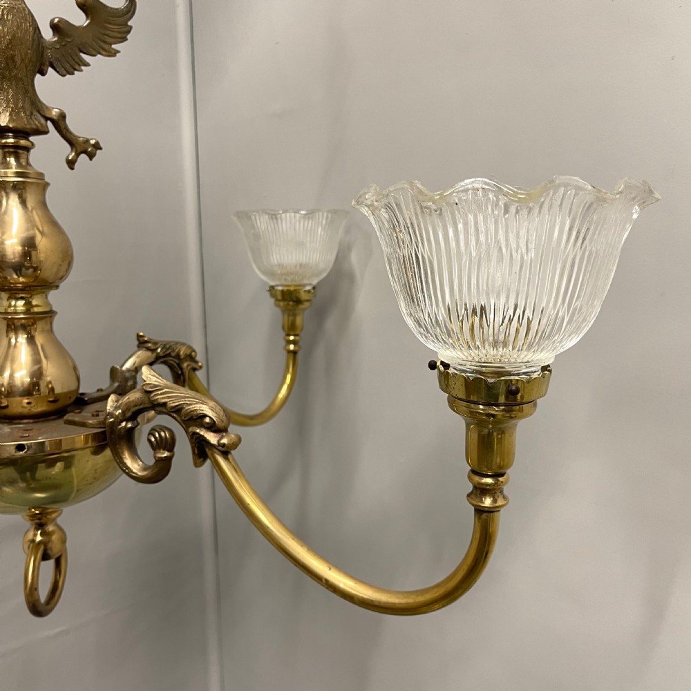 Large brass chandelier with holophane shades  View III