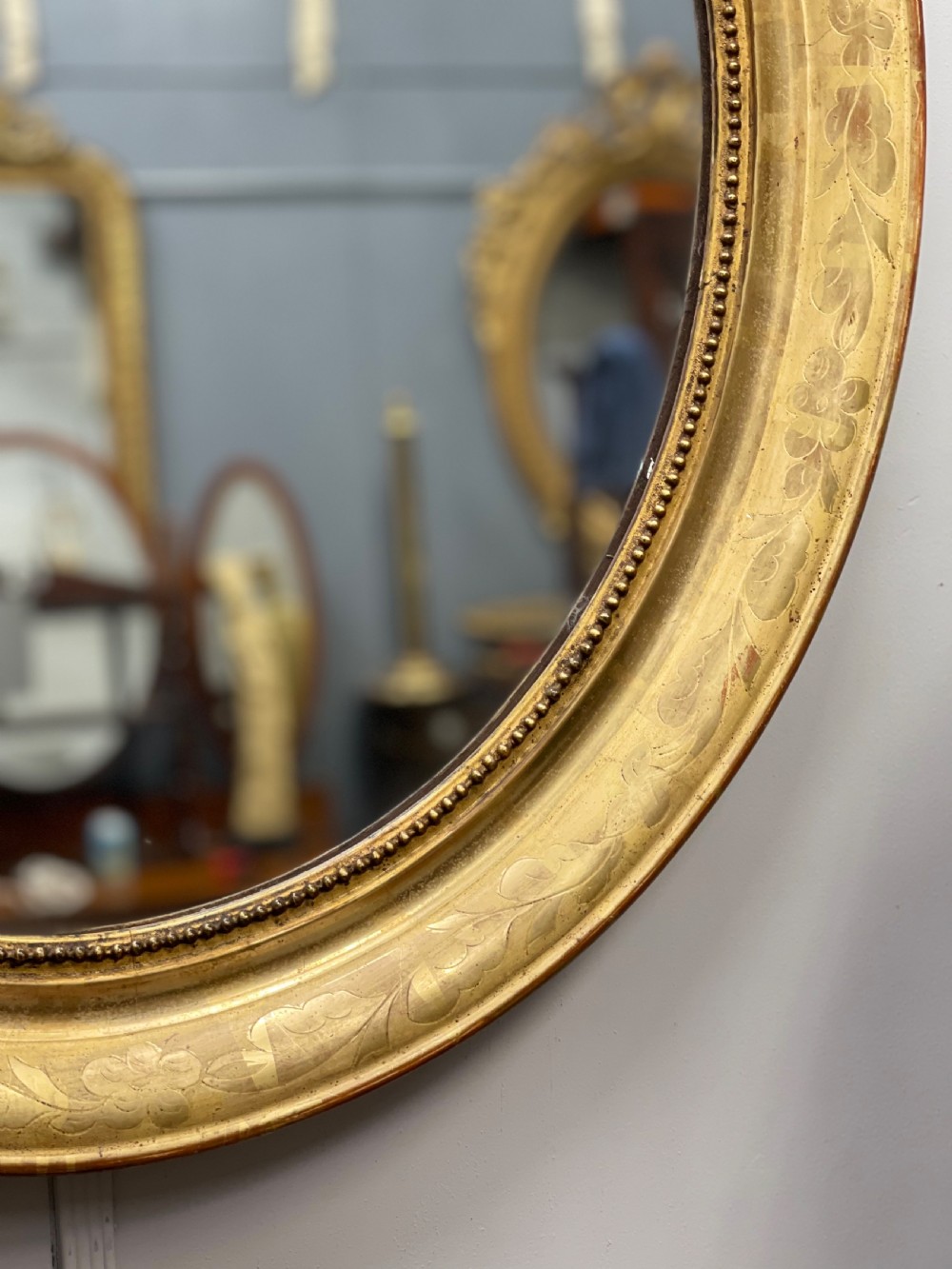 French oval figured gilt mirror View III