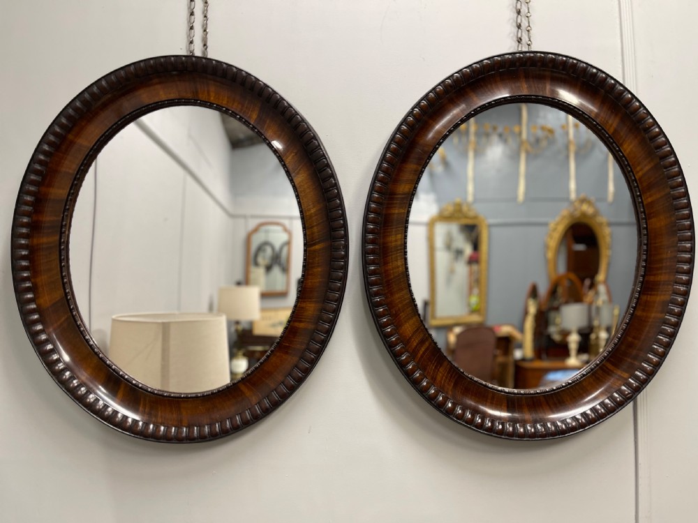Pair of rosewood oval mirrors 
