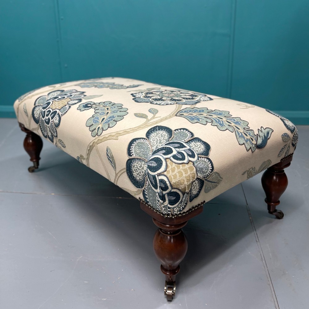Newly upholstered ottoman footstool on bulbous legs