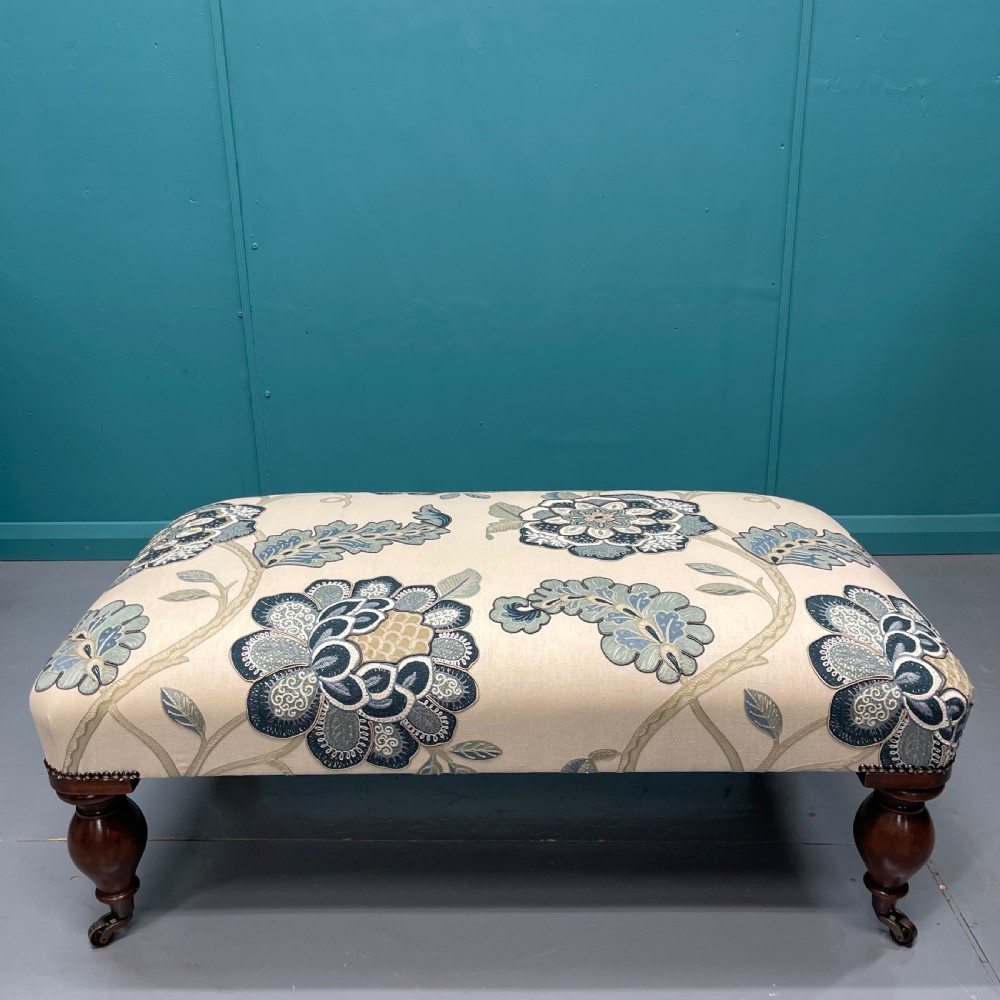 Newly upholstered ottoman footstool on bulbous legs View II