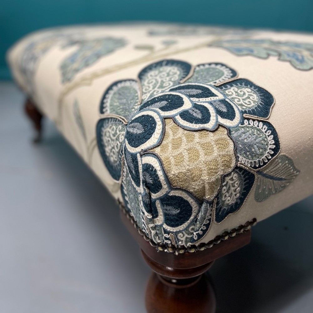 Newly upholstered ottoman footstool on bulbous legs View III