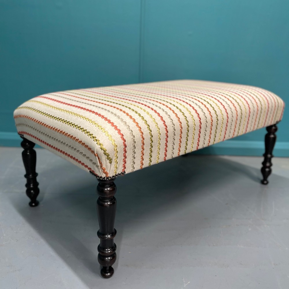 Newly upholstered ottoman stool on ebonised legs  View III