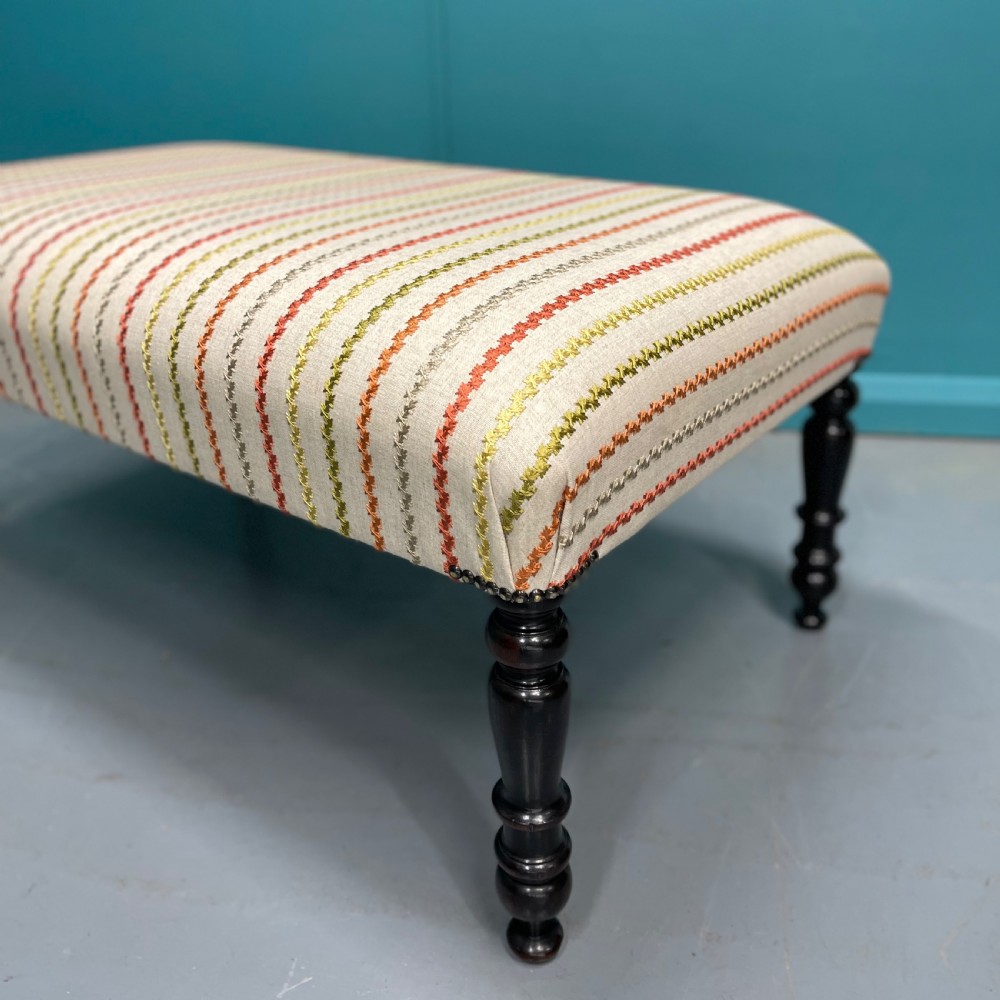 Newly upholstered ottoman stool on ebonised legs  View IV