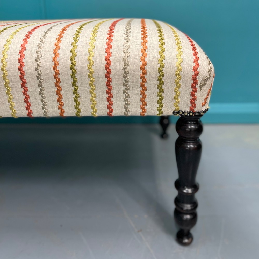 Newly upholstered ottoman stool on ebonised legs  View V
