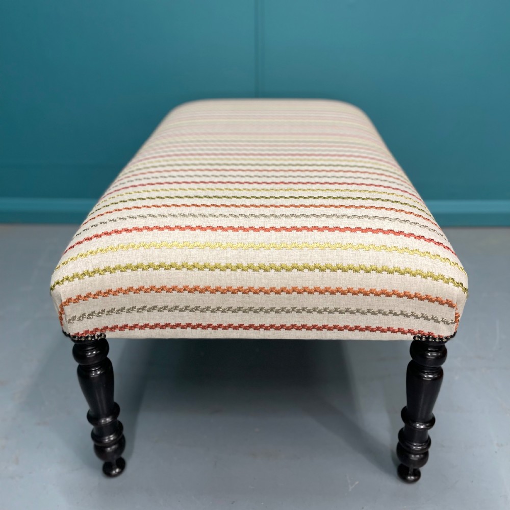 Newly upholstered ottoman stool on ebonised legs  View VI