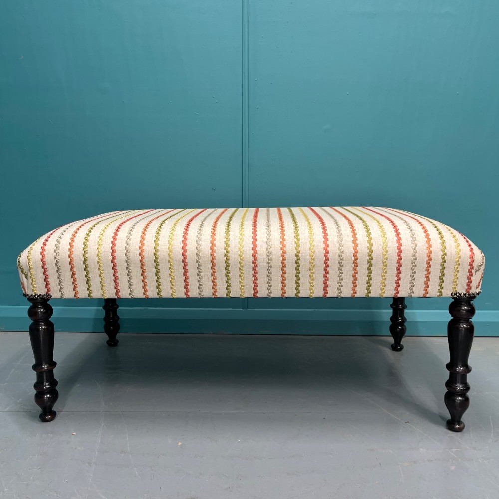 Newly upholstered ottoman stool on ebonised legs  View VIII