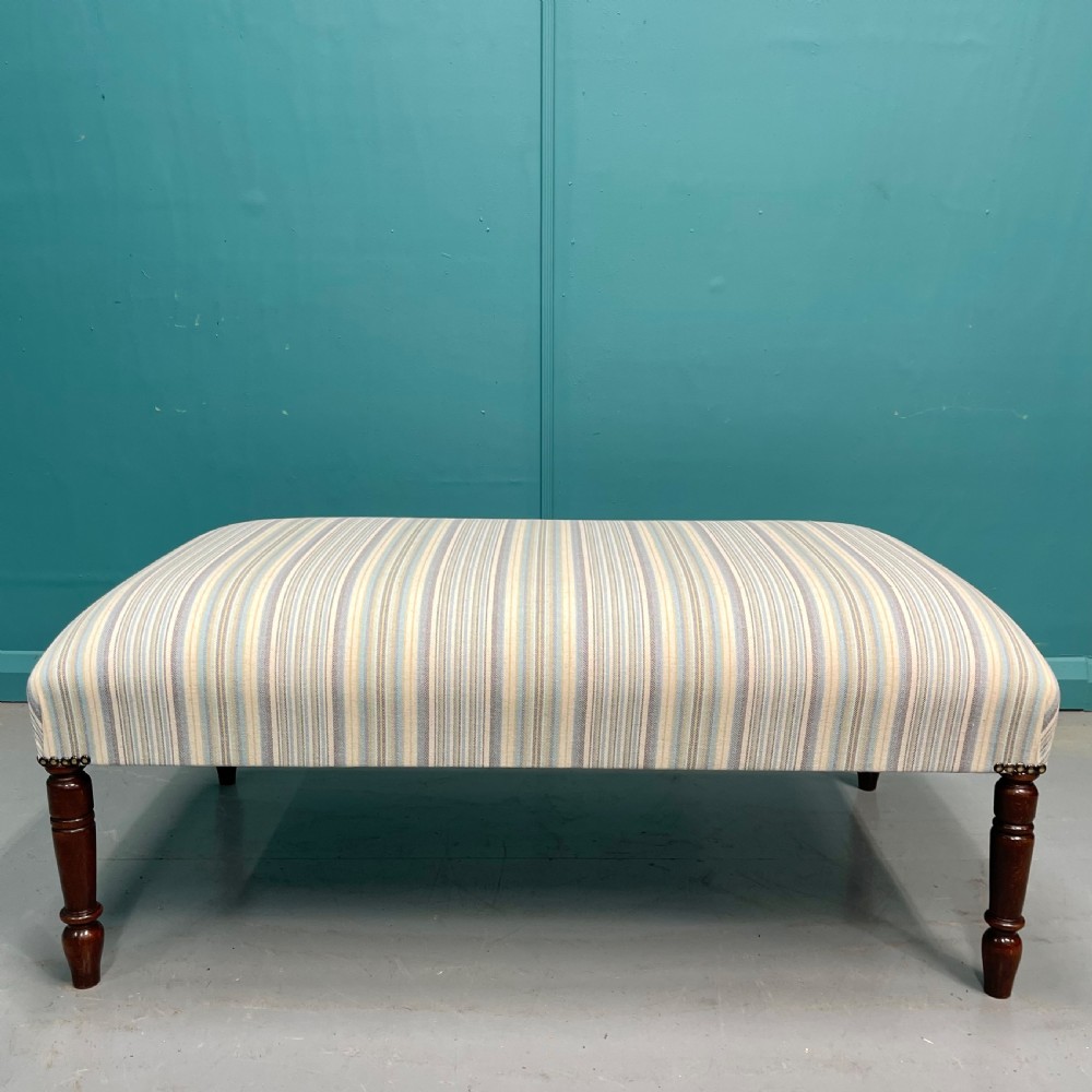 Newly upholstered pastel stripe ottoman stool