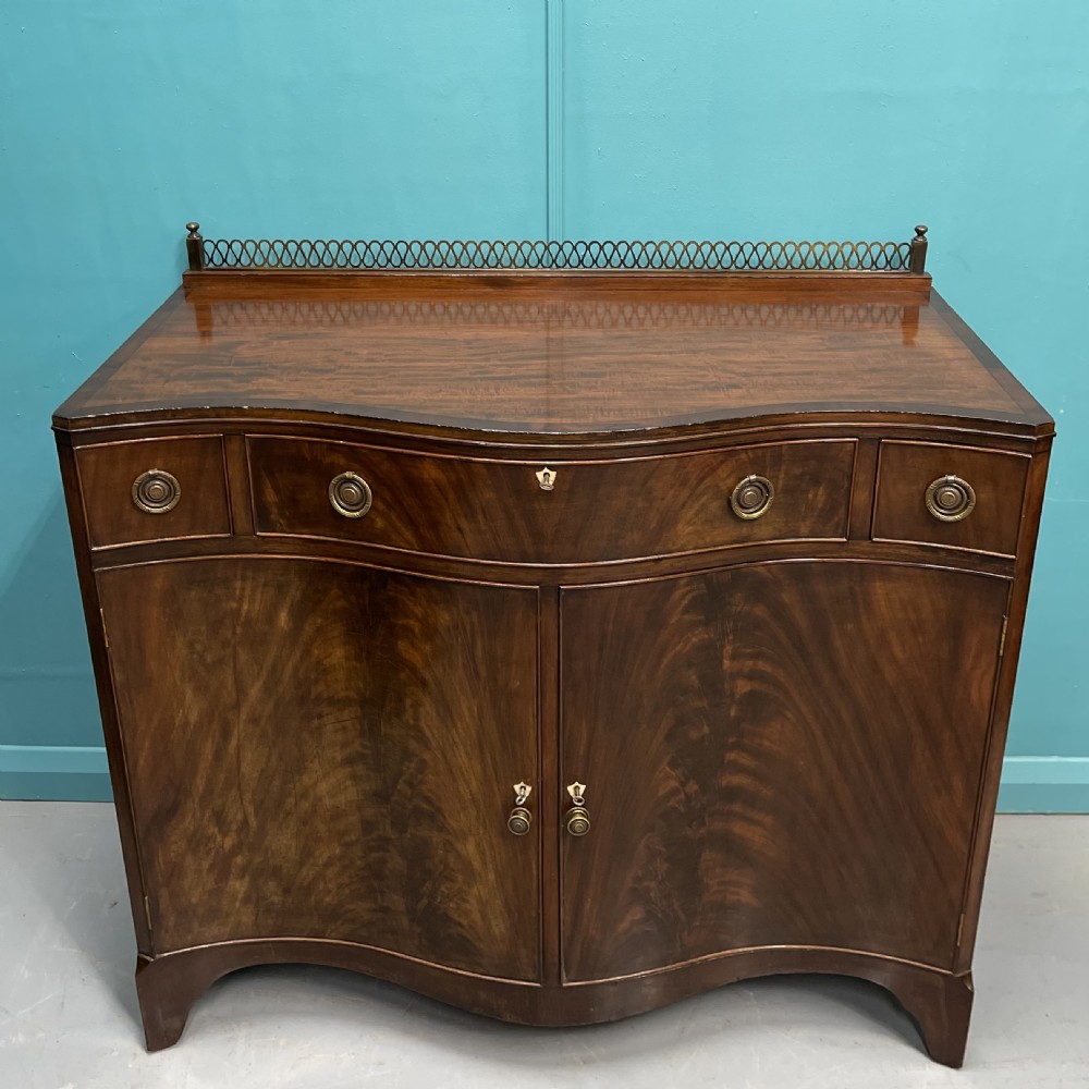 Serpentine mahogany server sideboard with brass gallery