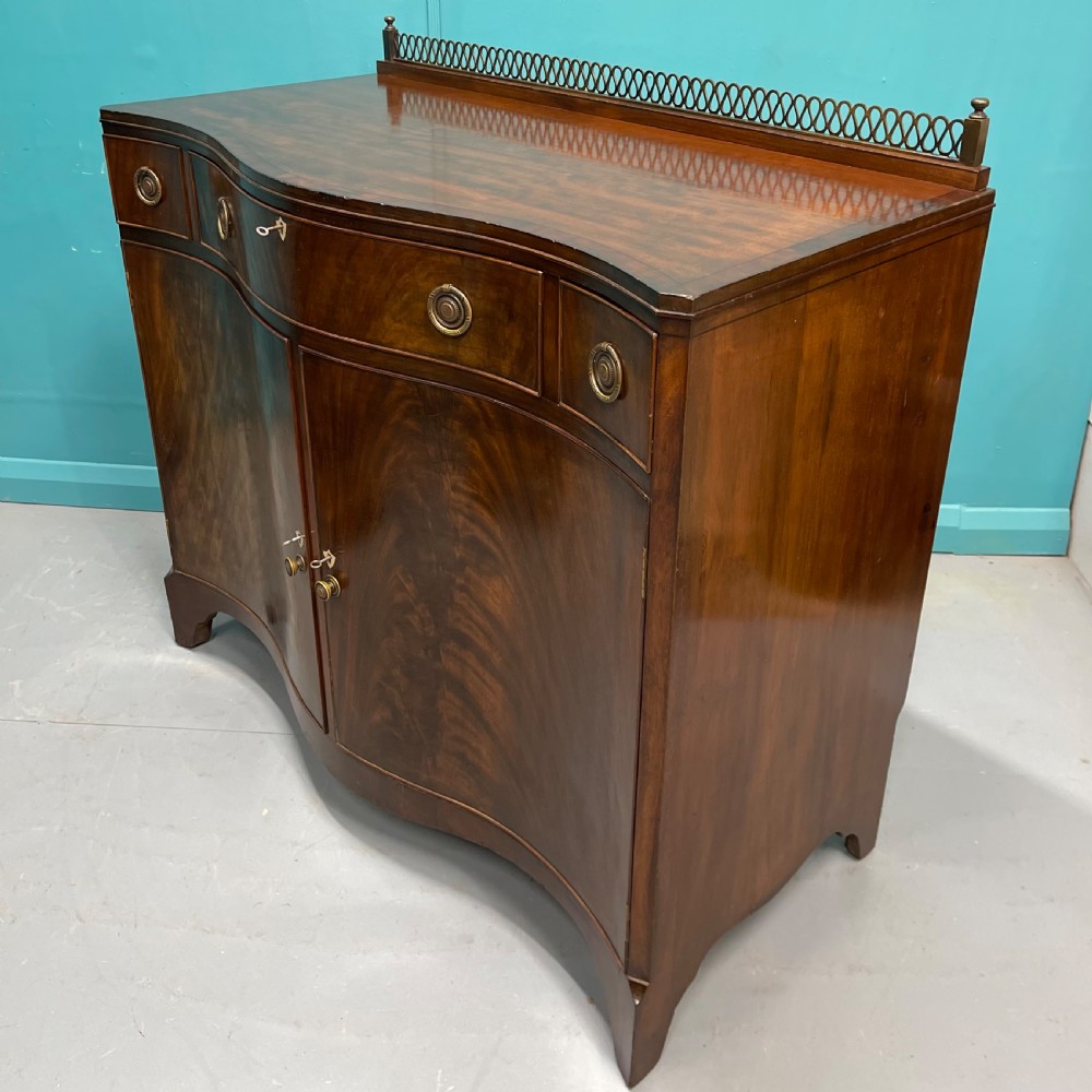 Serpentine mahogany server sideboard with brass gallery View VI