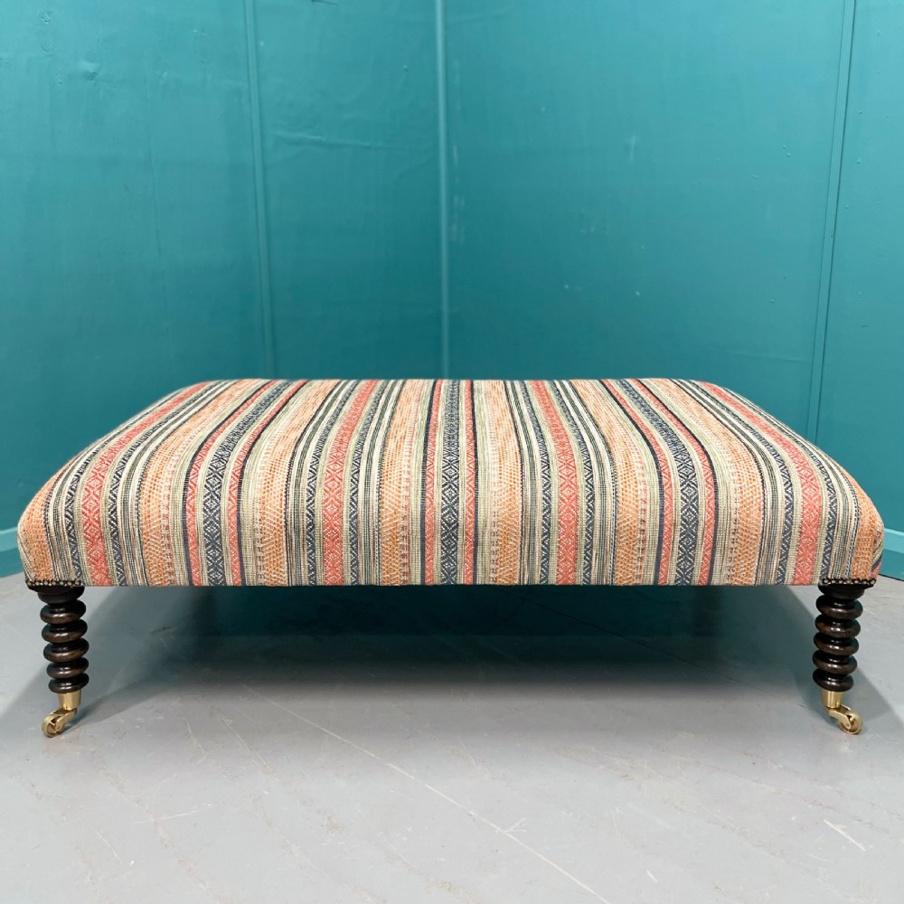 Large newly upholstered bobbin stool on castors