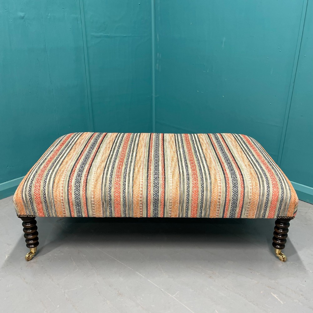Large newly upholstered bobbin stool on castors View V