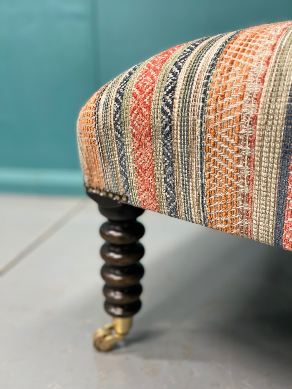 Large newly upholstered bobbin stool on castors View X