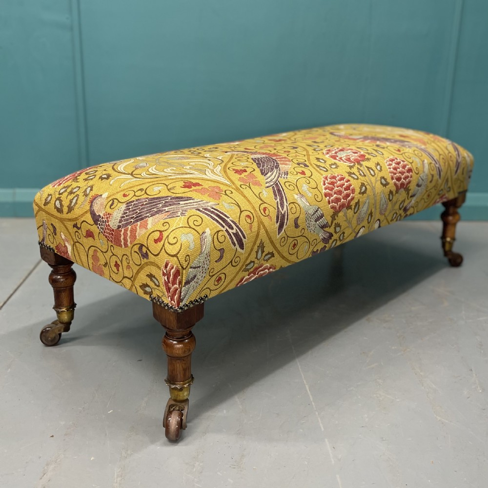 Victorian oak low footstool on castors 