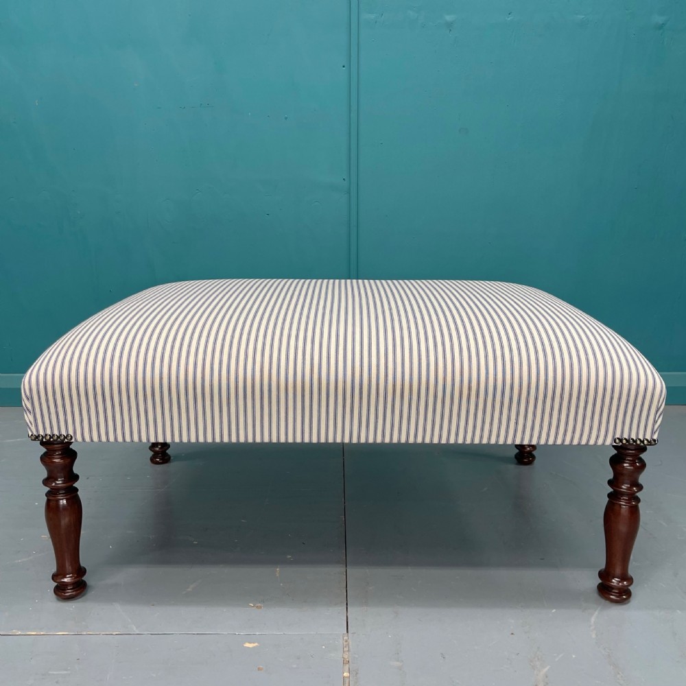 Newly upholstered blue ticking stripe footstool