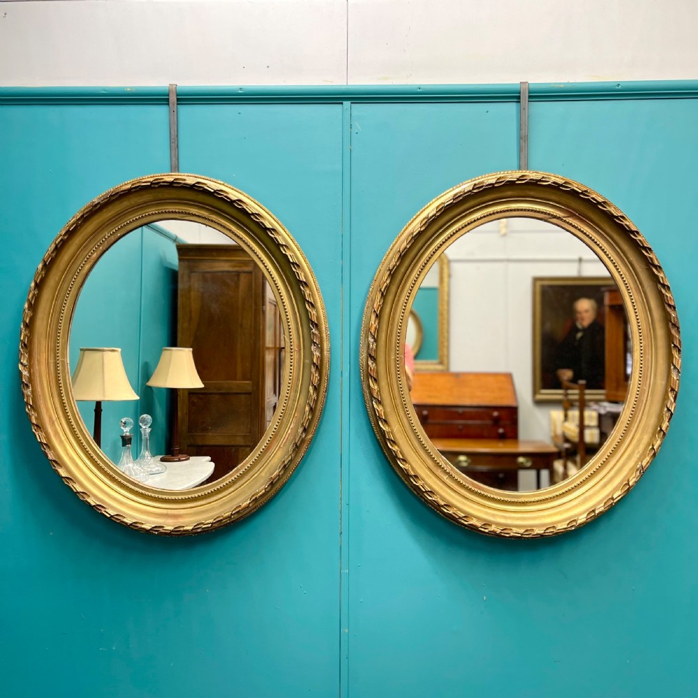 Large pair of French oval gilt mirrors