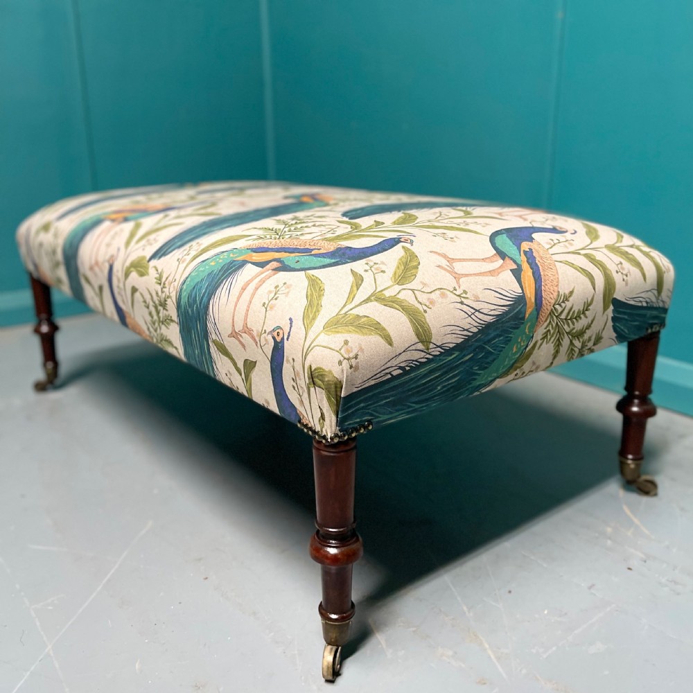 Newly upholstered peacocks centre footstool