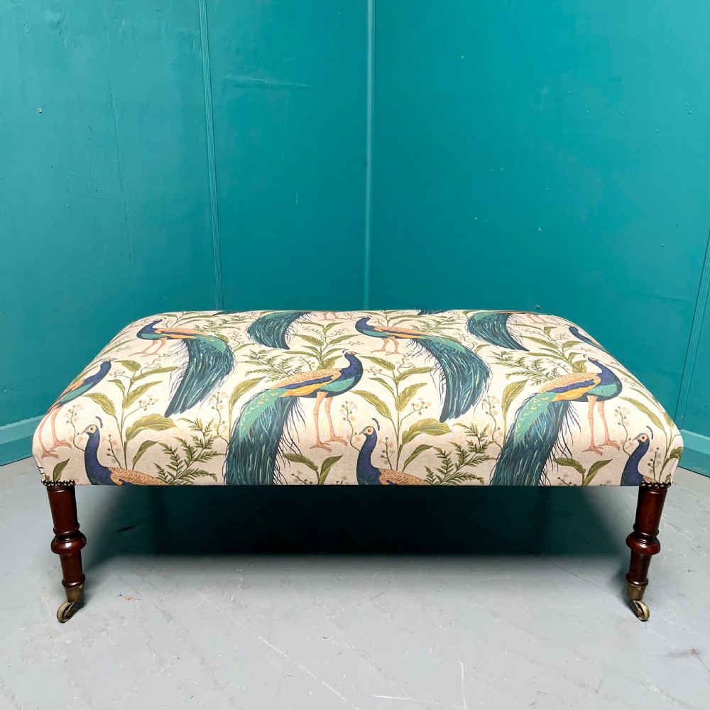 Newly upholstered peacocks centre footstool View III