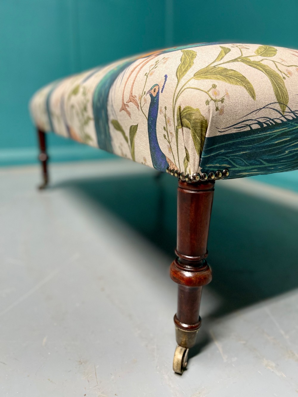 Newly upholstered peacocks centre footstool View V