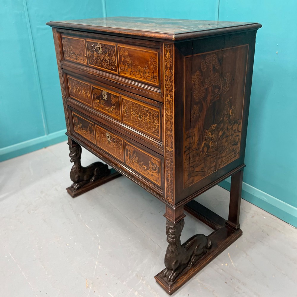 A nineteenth-century Italian walnut chest featuring three drawers decorated with detailed marquetry pictorial scenes and resting on carved base supports. View III