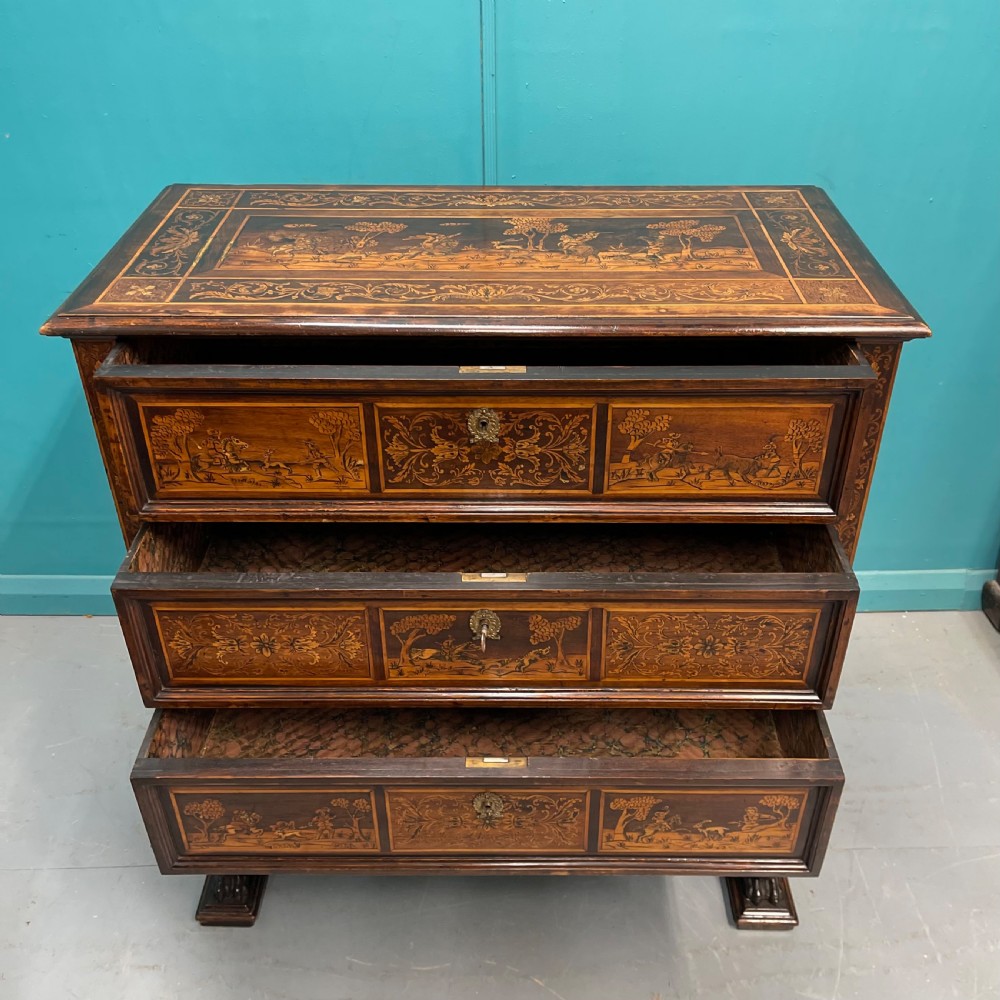 A nineteenth-century Italian walnut chest featuring three drawers decorated with detailed marquetry pictorial scenes and resting on carved base supports. View VI