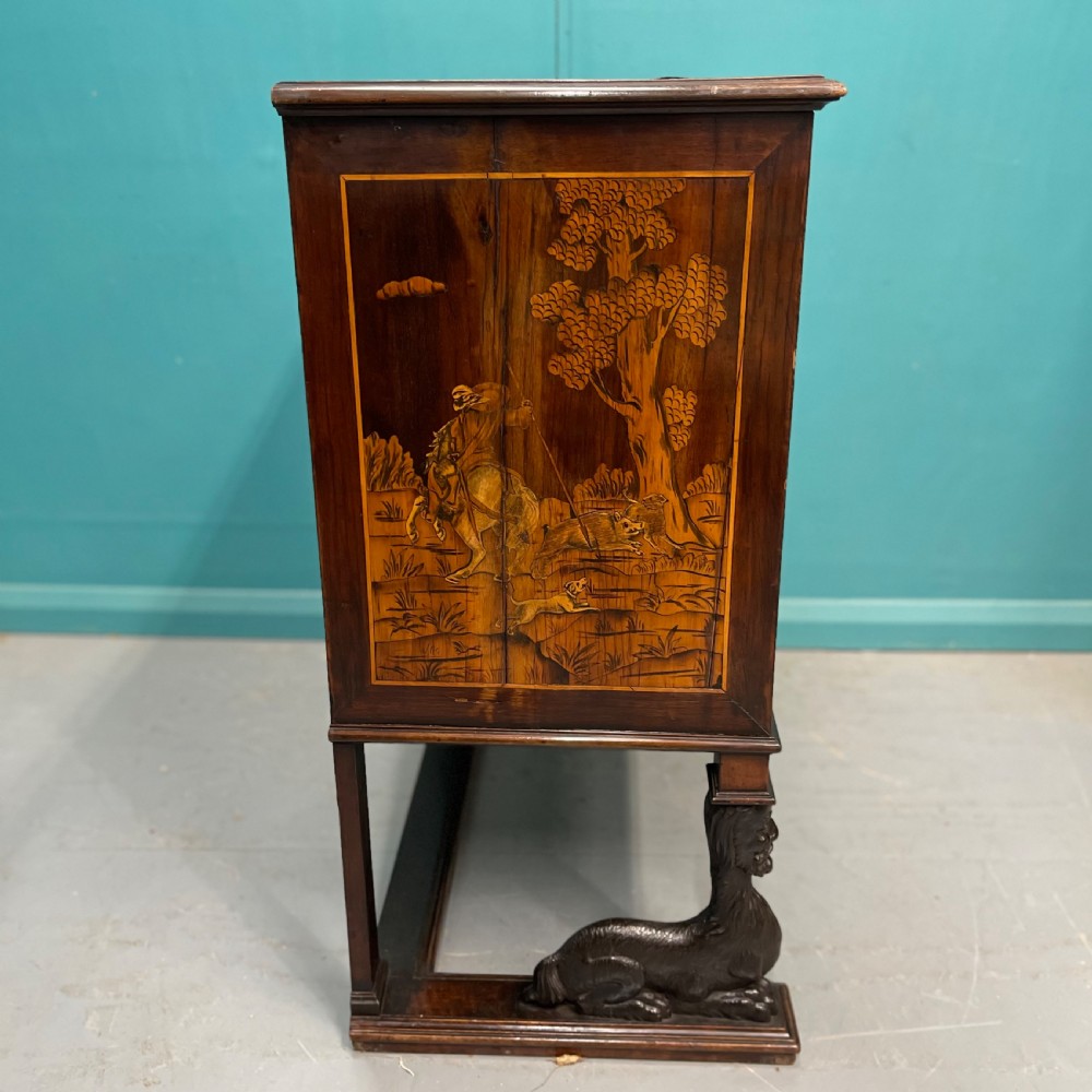 A nineteenth-century Italian walnut chest featuring three drawers decorated with detailed marquetry pictorial scenes and resting on carved base supports. View VII