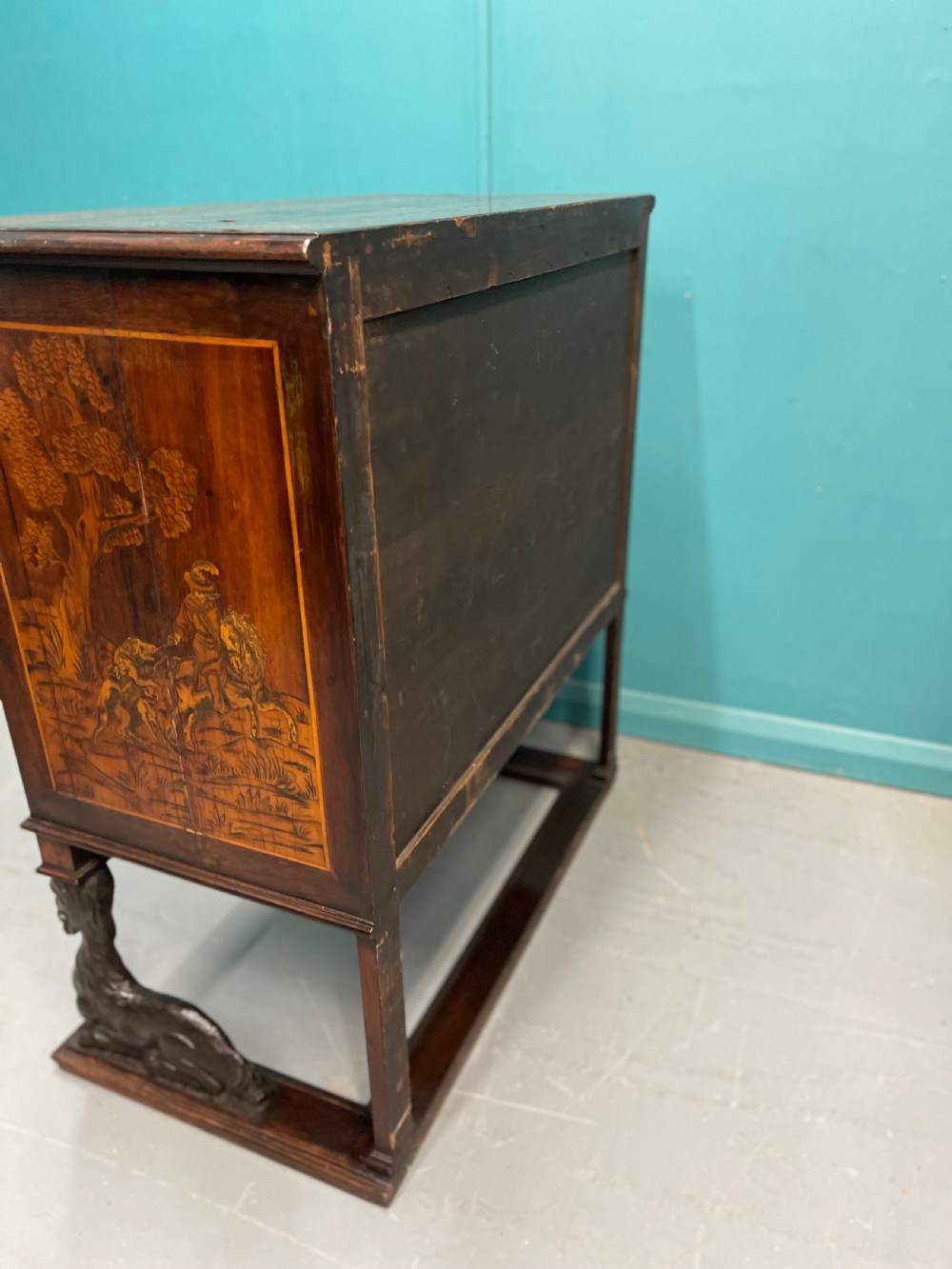 A nineteenth-century Italian walnut chest featuring three drawers decorated with detailed marquetry pictorial scenes and resting on carved base supports. View X
