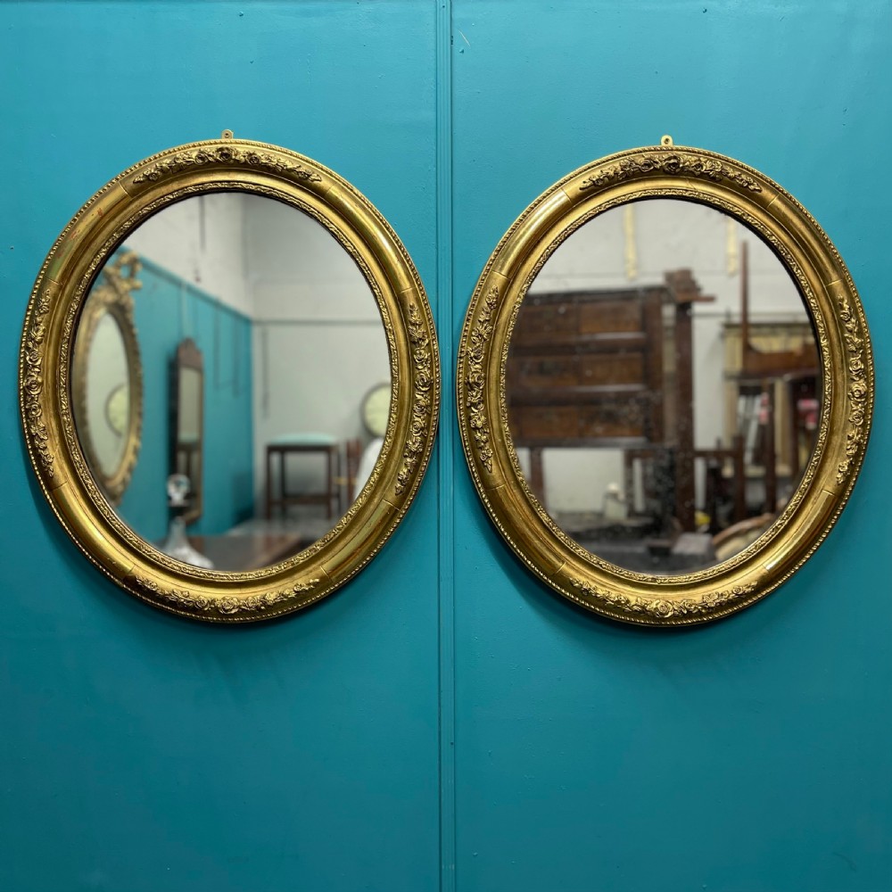 Large pair of French oval gilt mirrors