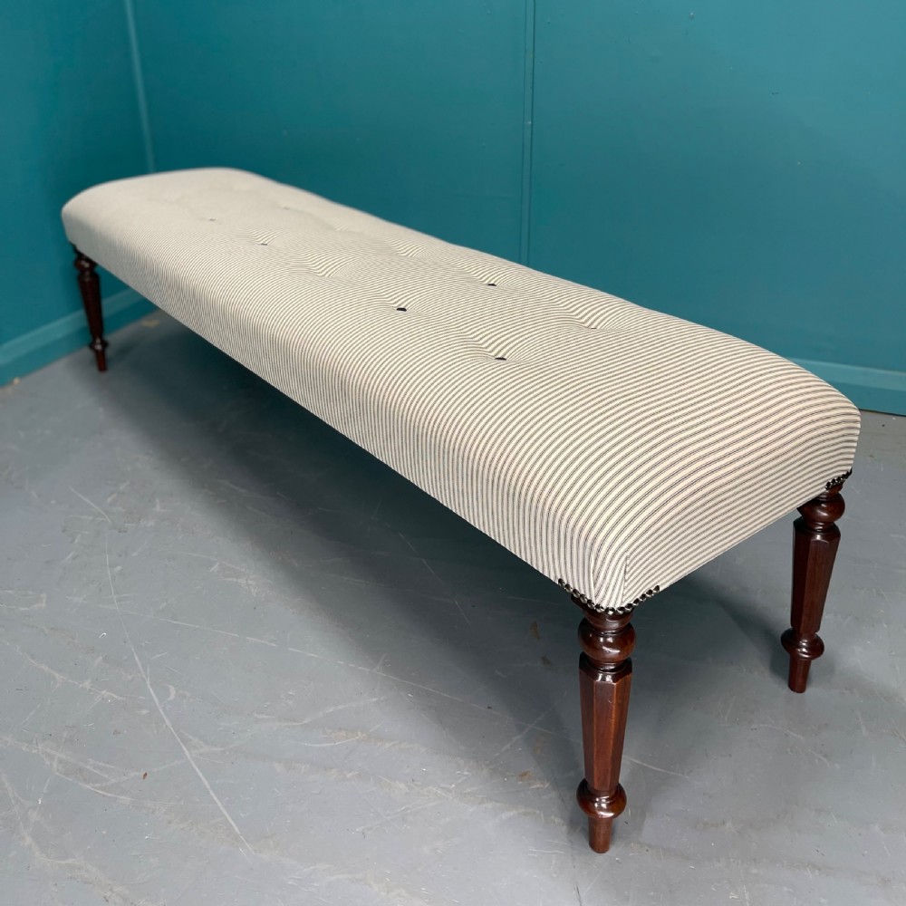 Newly upholstered 6 foot long stool in buttoned ticking
