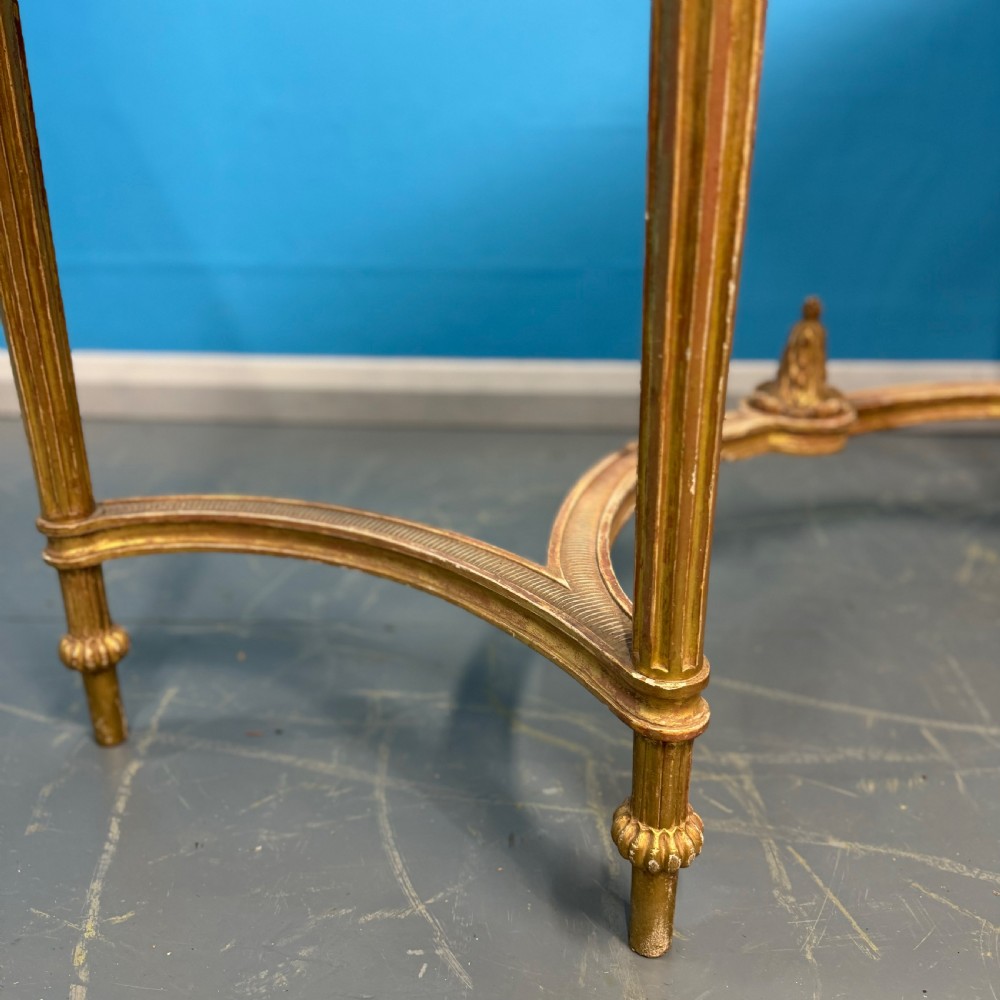 An Adam style giltwood console table featuring a dark green marble top, fluted frieze with swag carvings, and slender tapered legs. View IX